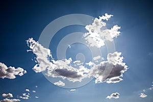 Various white and dark clouds against a dark blue sky