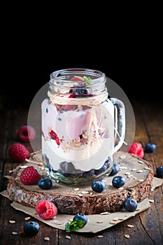 Various wild fruits on yogurt cream in rustic style