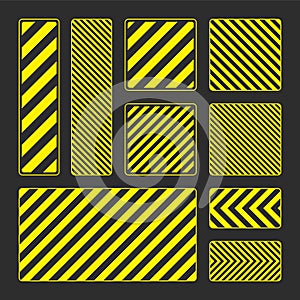 Various yellow warning signs with diagonal lines. Attention, danger or caution sign, construction site signage