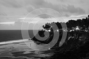 Varkala beach at night, various cafes and restaurants at the cliff in Kerala, India. Black and white