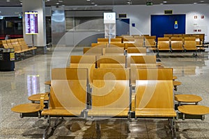 varnished wooden chairs in one of the waiting rooms at Cristiano Ronaldo airport photo