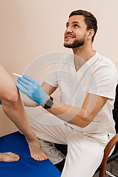 The vascular surgeon is marking leg veins. Vein markup. The phlebologist is marking legs before surgery to remove the