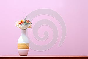 Vase against purple wall