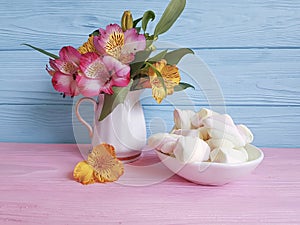 Vase with alstroemeria wooden background marshmallow, sweetness
