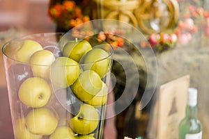 Vase with apples on beautiful background clouseup