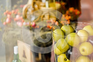 Vase with apples on beautiful background clouseup