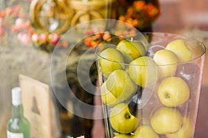 Vase with apples on beautiful background clouseup