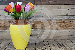 Vase with artificial flowers, colorful tulips