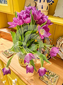 Vase of beautiful flowers. Pink and yellow tulips.