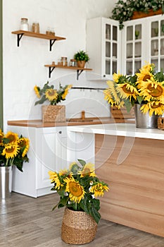 Vase with beautiful yellow sunflowers in the kitchen