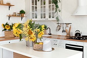 Vase with beautiful yellow sunflowers in the kitchen