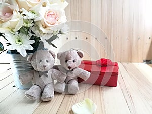 Vase of bouquet Roses in aluminium bucket and lovely couple bear on pink background.
