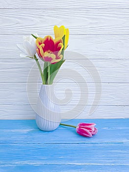 Vase bouquet of tulips decor home springtime colorful romantic elegance on wooden background