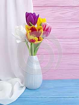 Vase bouquet of tulips colorful romantic elegance on wooden background