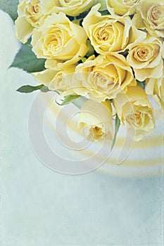 Vase with a bouquet of yellow spring roses