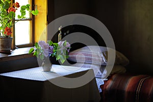 Vase of flowers in the bedroom of an old house