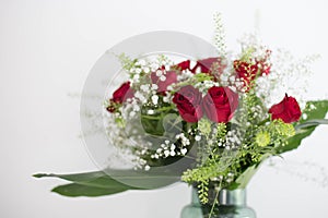 Vase of flowers red roses on white background thank you and love card design room for text