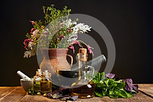 Vase with fresh herbs and flowers