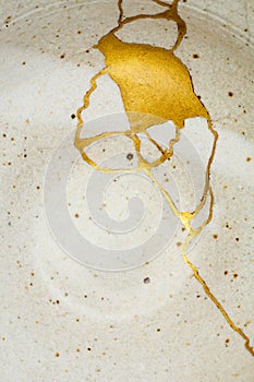 A kintsugi repaired bowl with gold. photo