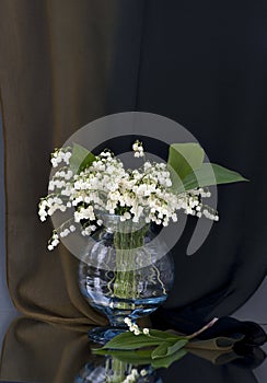 Vase with lily of the valley flowers