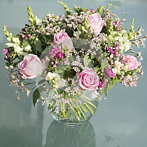 Vase with rose and pink flowers, roses, snapdragons and other flowers photo