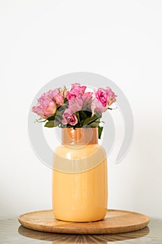 A vase of pink roses isolated on a white background