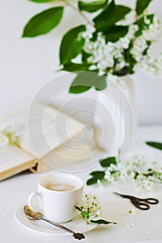 Vase with White Flowers Bird Cherry Tree, Morning, Cup with Coffee, Old Book