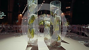 Vases with white flowers on the table in the hall