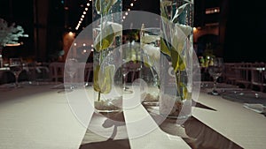 Vases with white flowers on the table in the hall