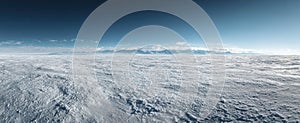 Vast arctic tundra under clear blue sky with distant mountain range in winter