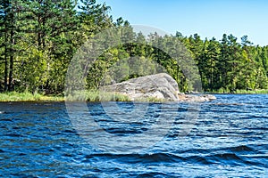 Russia, Lake Ladoga, August 2020. A huge granite boulder near the shore of the lake.