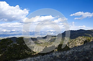 Vast Mountain View with Sunlight and Cloud Shadows photo