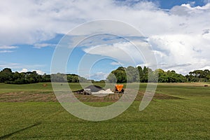 Vast, open expanse of land with a sandy pit situated in its center