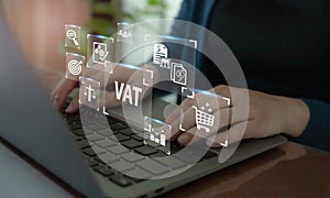 VAT concept. Value Added Tax. Officer working on computer with VAT text and iconon smart background