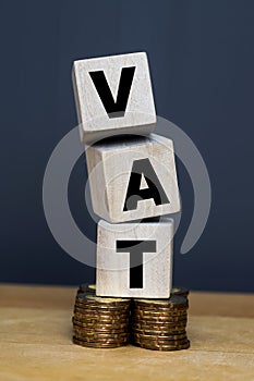 VAT Concept. Word VAT with stacked coins