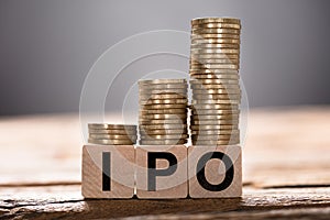 Stacked Coins On Ipo Wooden Blocks photo