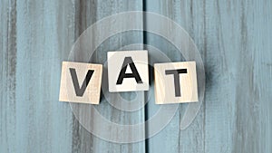 Vat on wooden cubes over blur background with copy spcae, financial photo