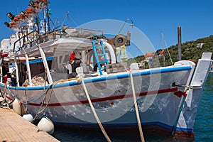 Vathy town, Meganisi island, Ionian Sea, GREECE-JULY 30, 2023: Fishing boat in Vathy Harbor. photo