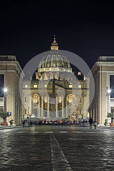 Saint Peter`s basilica facade and square by night