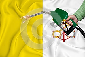 VATICAN flag Close-up shot on waving background texture with Fuel pump nozzle in hand. The concept of design solutions. 3d