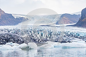 Vatnajoekull glacier in Iceland deep blue ice and layers of ash from volcanic eruptions