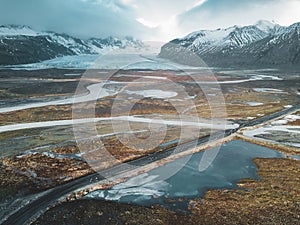 Vatnajokull glacier aerial drone image with street highway and clouds and blue sky. Dramatic winter scene of Vatnajokull