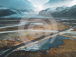 Vatnajokull glacier aerial drone image with street highway and clouds and blue sky. Dramatic winter scene of Vatnajokull