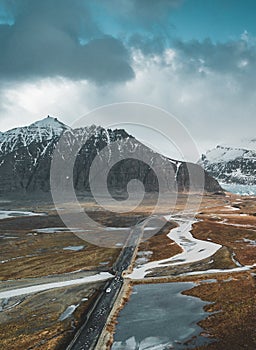 Vatnajokull glacier aerial drone image with street highway and clouds and blue sky. Dramatic winter scene of Vatnajokull