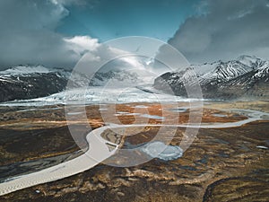 Vatnajokull glacier aerial drone image with street highway and clouds and blue sky. Dramatic winter scene of Vatnajokull