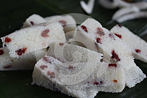 Vattayappam slices. Steamed spongy rice cake topped with dried cranberries
