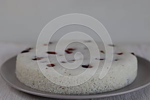 Vattayappam. Steamed spongy rice cake topped with dried cranberries