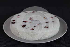 Vattayappam. Steamed spongy rice cake topped with dried cranberries