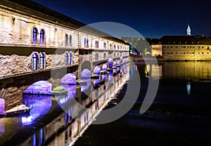 The Vauban Dam and Commanderie Saint-Jean building at night in Strasbourg, France