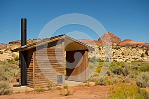 A vault toilet in the desert